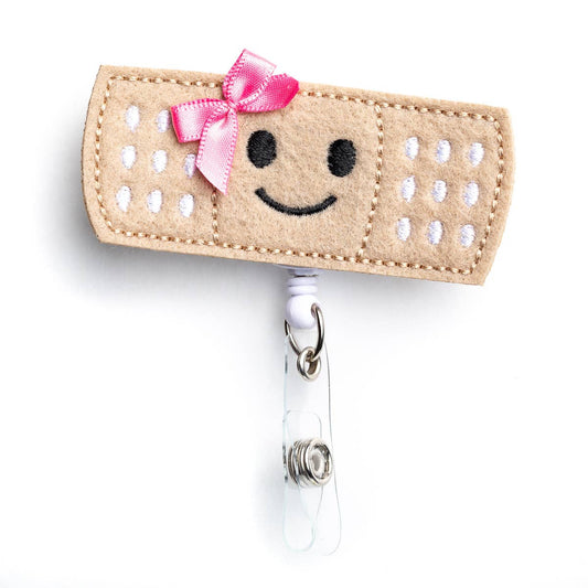 pink bow bandage badge reel